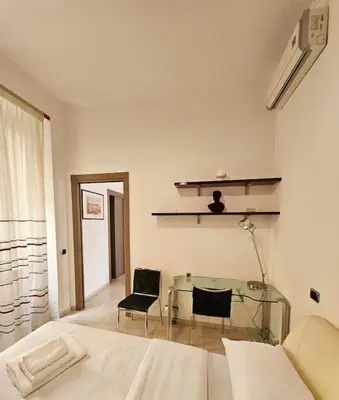 a bedroom with a bed and a glass table at Appartamento vista Colosseo in Rome
