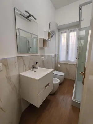 a bathroom with a sink and a toilet and a mirror at San Pietro Green Home in Rome