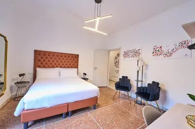 a bedroom with a large bed and two chairs at B&B ErinaHouse in Rome
