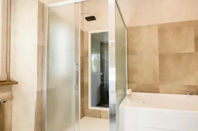 a shower with a glass door in a bathroom at Caffarella Suite in Rome