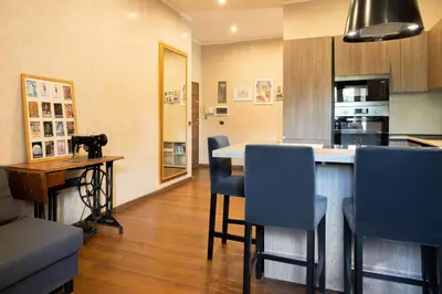 a kitchen with a bar with chairs and a table at Caffarella Suite in Rome