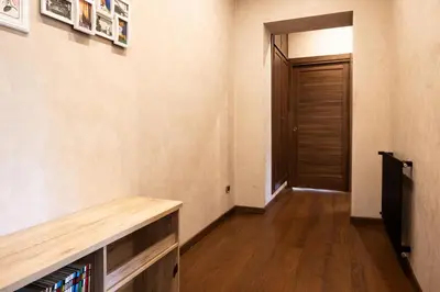 a hallway with a wooden table and a door at Caffarella Suite in Rome