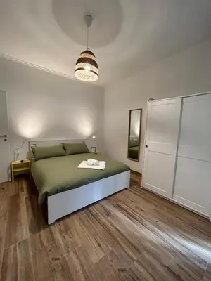 a bedroom with a bed and a pendant light at Appia Little Charme 44 in Rome
