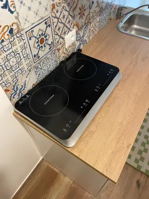 a tablet computer sitting on top of a kitchen counter at Appia Little Charme 44 in Rome