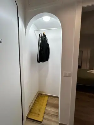 a black bag hanging on a wall in a room at Appia Little Charme 44 in Rome
