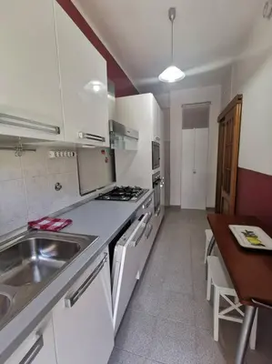 a bedroom with a bed and a dresser in it at La Regina Tiberina in Rome