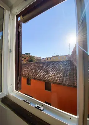 a window with a view of a roof at The Artful Flat in Rome