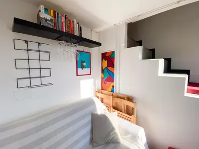 a bedroom with a bed and some shelves at The Artful Flat in Rome
