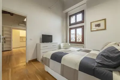 a bedroom with a bed and a television in it at HC - Palazzo Altieri Exclusive Penthouses in Rome