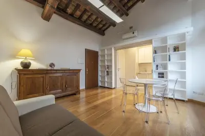 a living room with a couch and a table and chairs at HC - Palazzo Altieri Exclusive Penthouses in Rome