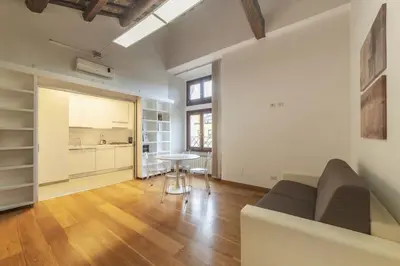 a living room with a couch and a table at HC - Palazzo Altieri Exclusive Penthouses in Rome