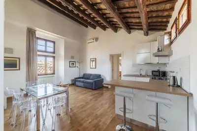 a kitchen and living room with a table and chairs at HC - Palazzo Altieri Exclusive Penthouses in Rome