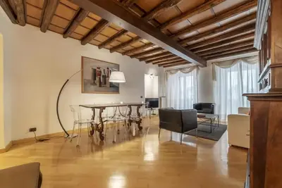 a living room with a dining room table and chairs at HC - Live Roma Pantheon View in Rome