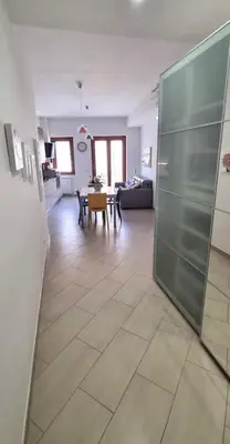 a living room with a large glass door in a room at Caffarella Garden and Park Apartment in Rome