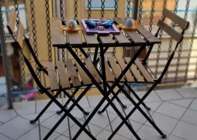 a wooden table with two cups and a plate on it at Caffarella Garden and Park Apartment in Rome