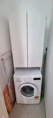 a washing machine with a white cabinet on top of it at Caffarella Garden and Park Apartment in Rome