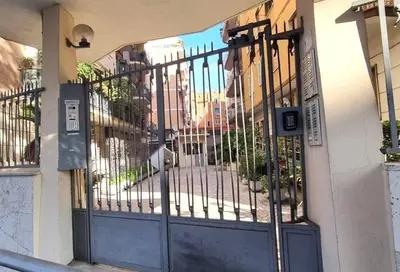 a gate on the side of a building at Caffarella Garden and Park Apartment in Rome