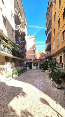 an empty street in a city with tall buildings at Caffarella Garden and Park Apartment in Rome