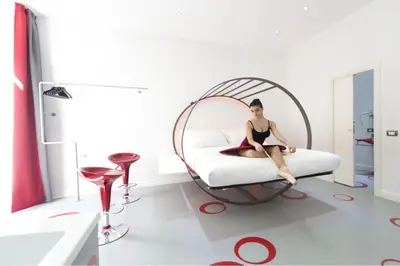 a woman sitting on a bed in a room at Ripetta Relais in Rome