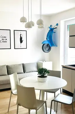 a living room with a table and a scooter on the wall at Simposio - Luxury Apartment Rome in Rome
