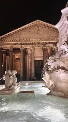 a large fountain in front of a building at Simposio - Luxury Apartment Rome in Rome