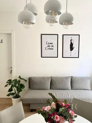 a living room with a couch and three pictures on the wall at Simposio - Luxury Apartment Rome in Rome