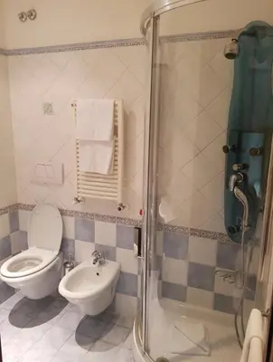 a bathroom with a toilet and a sink at 69 Manin Termini in Rome