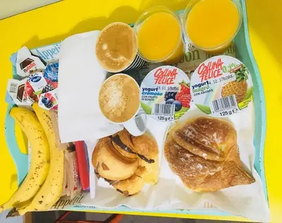 a tray of food with breakfast foods and drinks at 69 Manin Termini in Rome