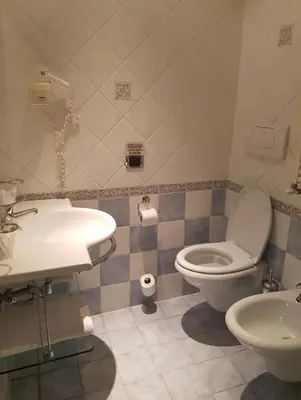 a bathroom with a toilet and a sink at 69 Manin Termini in Rome