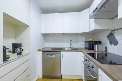 a kitchen with white cabinets and a sink at Appartamento a Piazza di Spagna in Rome