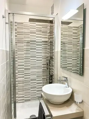a bathroom with a white sink and a mirror at Stelletta Apartment in Rome