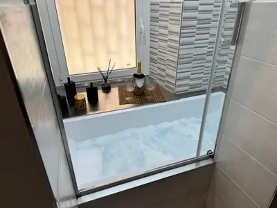 a bathroom with a shower with a window and a counter at Stelletta Apartment in Rome