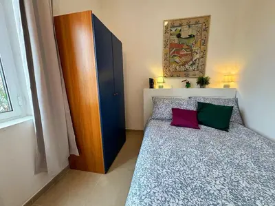 a bedroom with a bed with two colorful pillows at Blue Sky in Rome