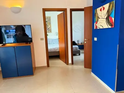 a room with a room with a tv and a blue door at Blue Sky in Rome