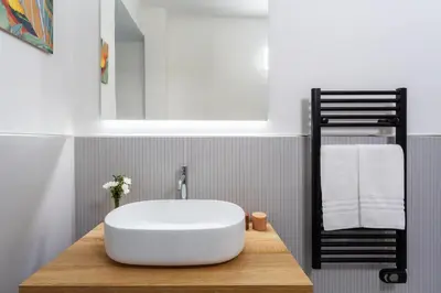 a bathroom with a large white tub on a wooden counter at Vatican 44 in Rome
