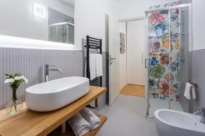 a bathroom with a large white tub and a shower at Vatican 44 in Rome