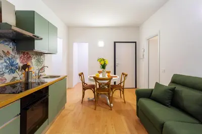 a kitchen and living room with a table and a couch at Vatican 44 in Rome