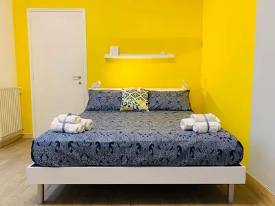 a bedroom with a bed with two towels on it at Portami in Villa -Gianicolo in Rome