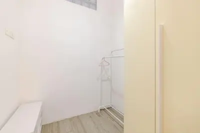 an empty room with white walls and wood floors at Portami in Villa -Gianicolo in Rome