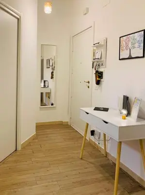 a room with a white desk and a wooden floor at Portami in Villa -Gianicolo in Rome