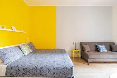 a bedroom with a bed and a couch at Portami in Villa -Gianicolo in Rome