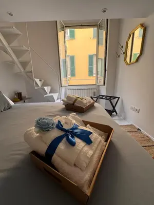 a box of towels with a blue bow on a bed at Hestya Domus in Rome