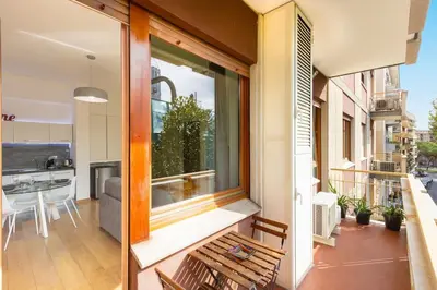 a balcony with a bench and a view of a kitchen at Dona's House in Rome