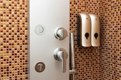a shower with two hair dryers on a wall at Dona's House in Rome