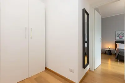 a hallway with white walls and a living room at Dona's House in Rome