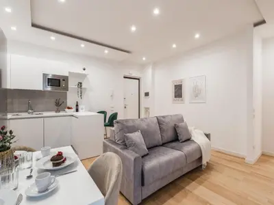a living room with a couch and a table at The Best Rent - Modern one-bedroom apartment in the Cipro area in Rome