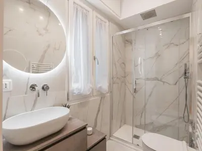 a white bathroom with a sink and a shower at The Best Rent - Modern one-bedroom apartment in the Cipro area in Rome