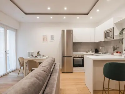 a living room with a couch and a kitchen at The Best Rent - Modern one-bedroom apartment in the Cipro area in Rome