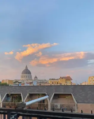 a bedroom with a large bed and a couch at Sunny Apartment with Stunning San Pietro View in Rome