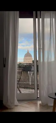 an open window with a view of a building at Sunny Apartment with Stunning San Pietro View in Rome